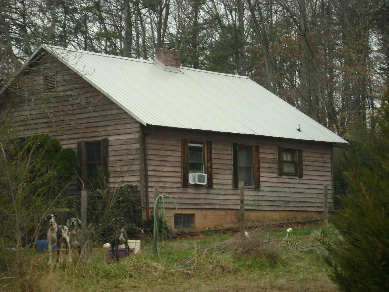 White metal roof on an old wood sided farmhouse, from a Metal Roof Installation job in Orange